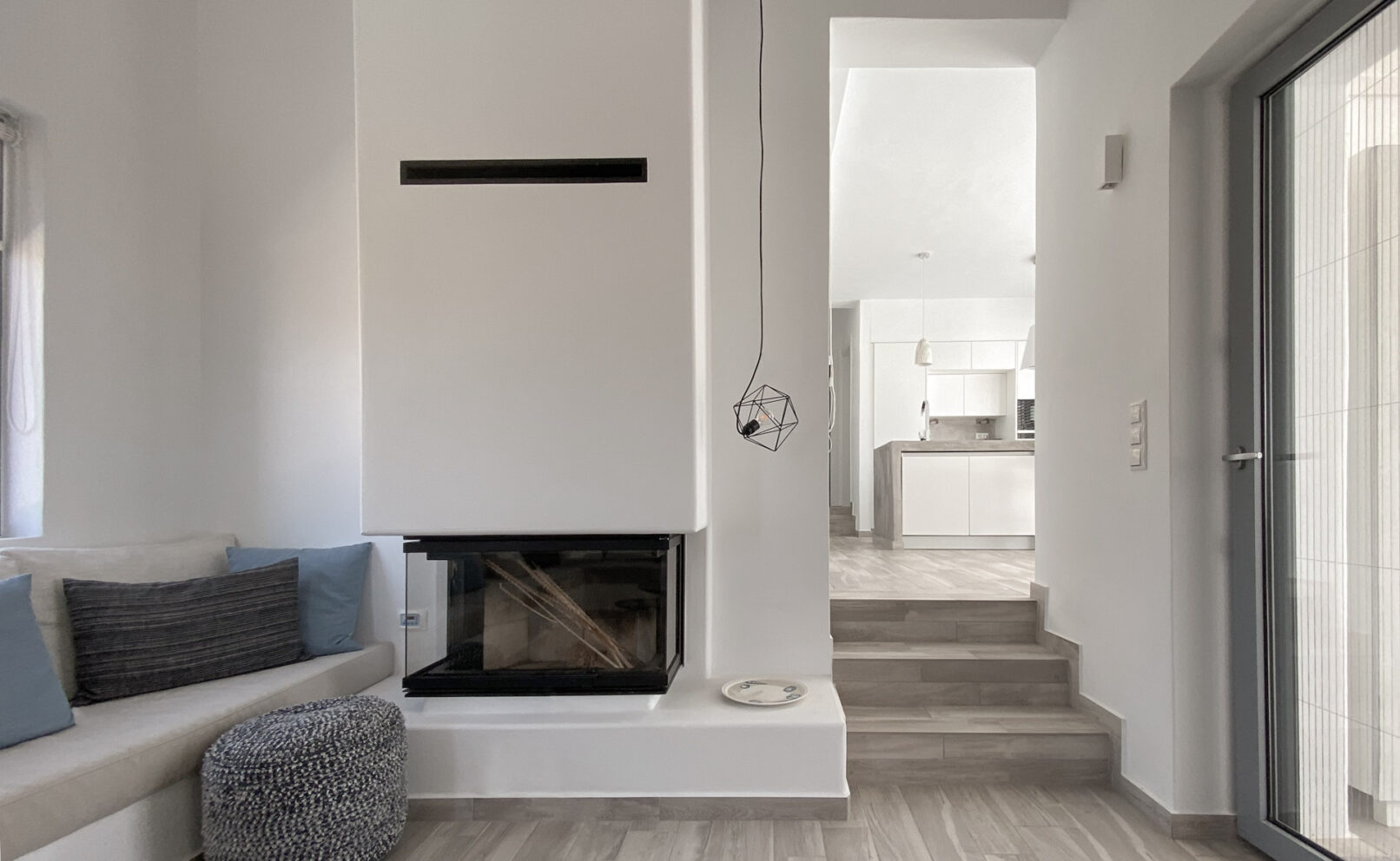 Pinthos Architects Naxos vacation summer house - villa. Cycladic island design in Aegean. Interior style fireplace