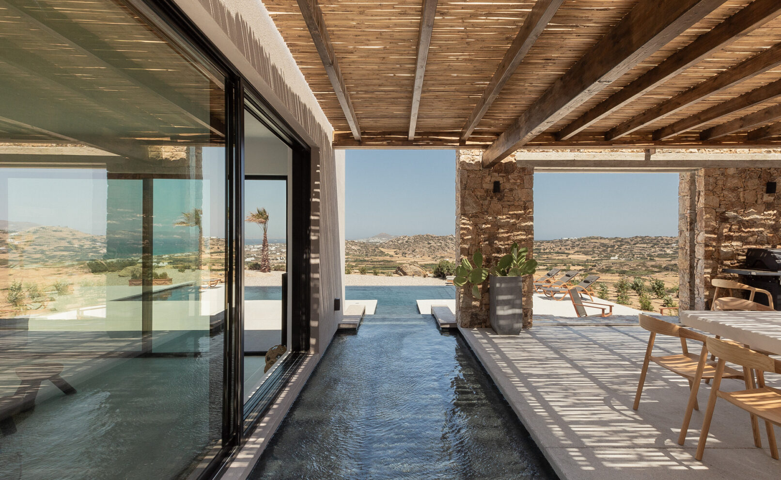 La Punta Villa in Naxos by PLINTHOS Architects: Cycladic architecture with stone, plaster, bioclimatic design, and stunning Aegean views.