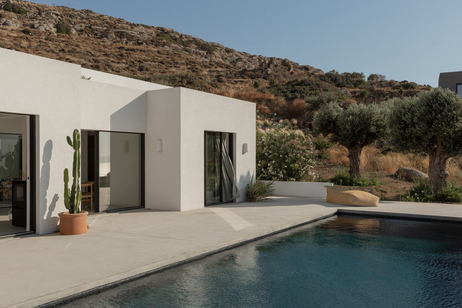 Discover La Natura Villas, an exclusive complex of luxury vacation homes in Naxos, designed by PLINTHOS Architects to blend seamlessly with the Cycladic landscape and offer breathtaking Aegean views.