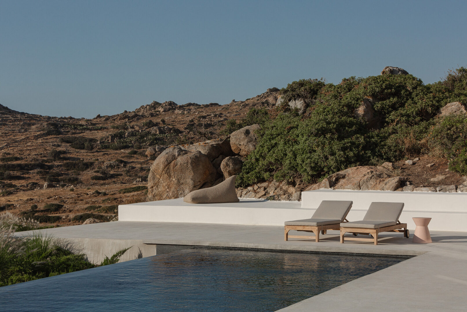 Discover La Natura Villas, an exclusive complex of luxury vacation homes in Naxos, designed by PLINTHOS Architects to blend seamlessly with the Cycladic landscape and offer breathtaking Aegean views.