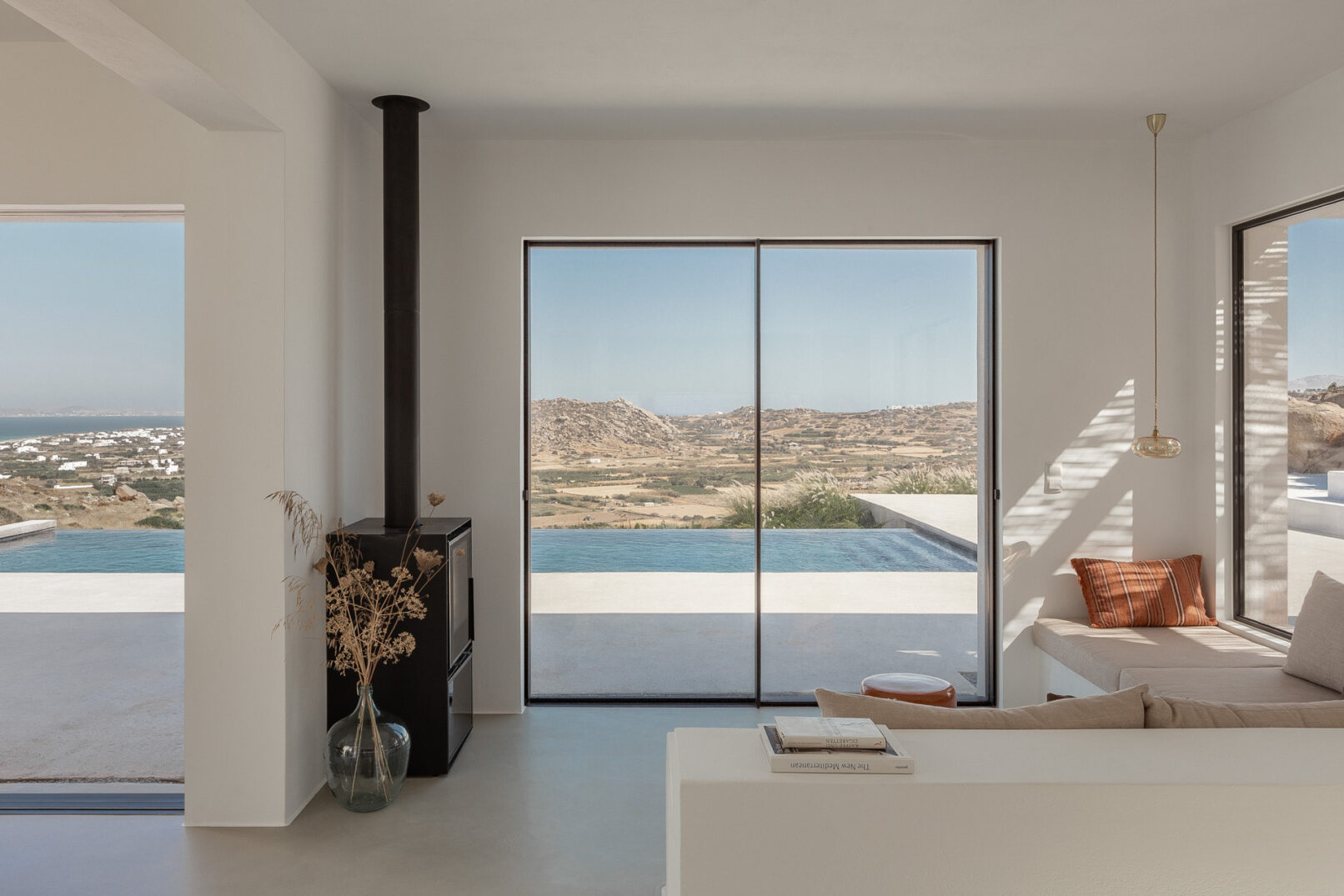 Discover La Natura Villas, an exclusive complex of luxury vacation homes in Naxos, designed by PLINTHOS Architects to blend seamlessly with the Cycladic landscape and offer breathtaking Aegean views.