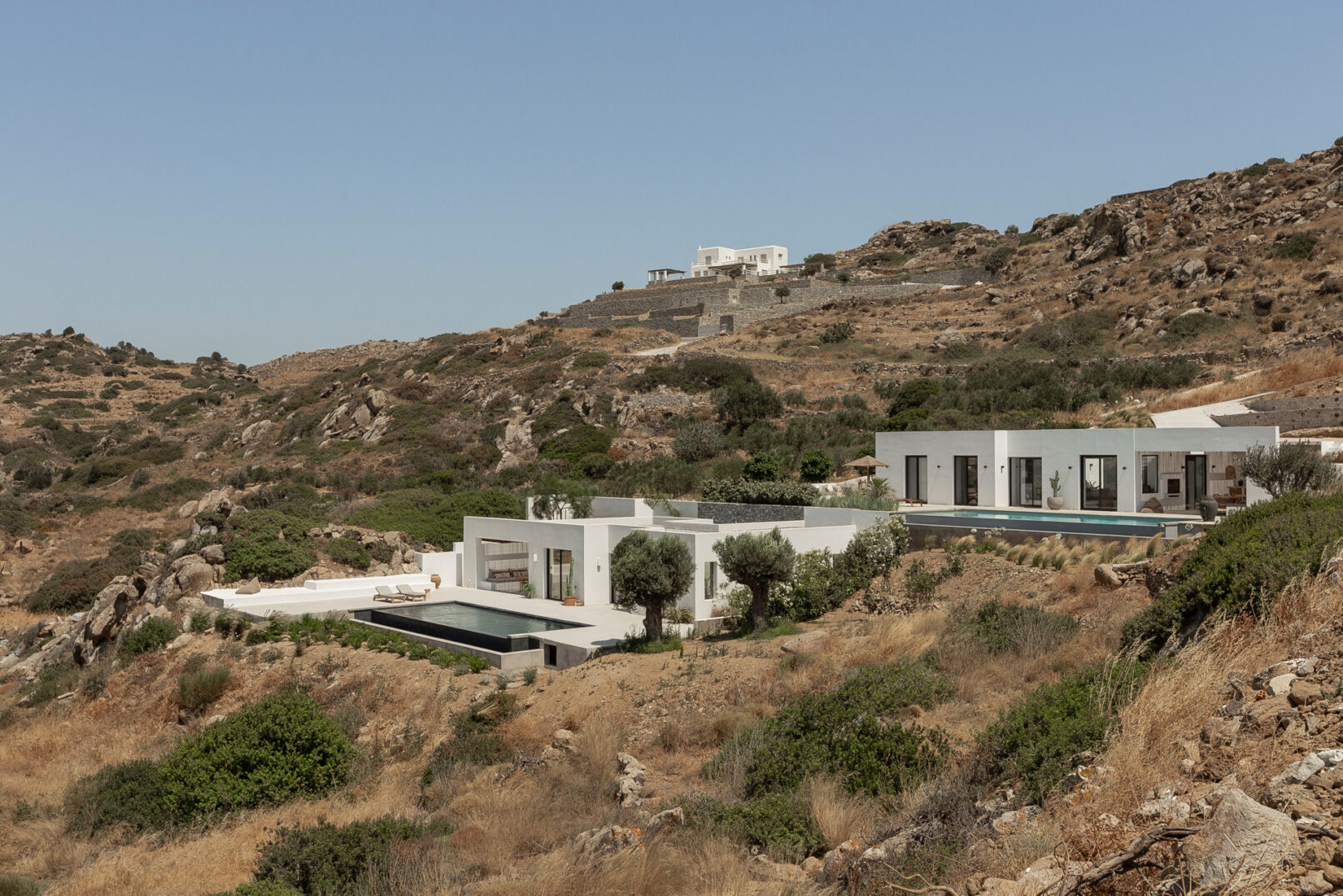 Discover La Natura Villas, an exclusive complex of luxury vacation homes in Naxos, designed by PLINTHOS Architects to blend seamlessly with the Cycladic landscape and offer breathtaking Aegean views.