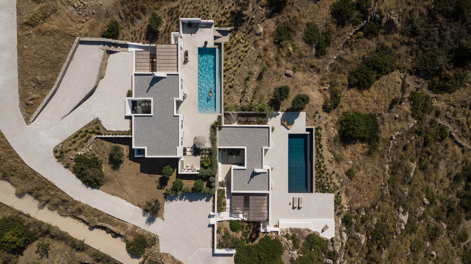 Discover La Natura Villas, an exclusive complex of luxury vacation homes in Naxos, designed by PLINTHOS Architects to blend seamlessly with the Cycladic landscape and offer breathtaking Aegean views.